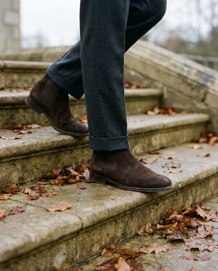 Brown suede chelsea boots on limestone steps