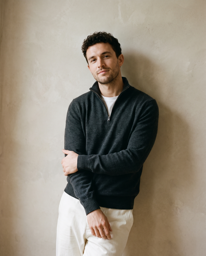 Man in a charcoal quarter-zip sweater