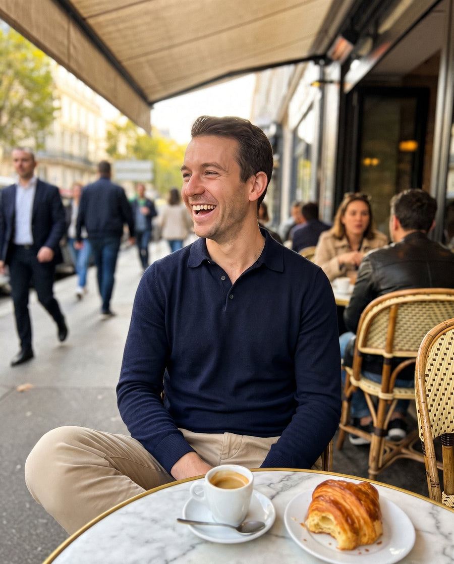 Man in a navy knit polo at a Paris cafe