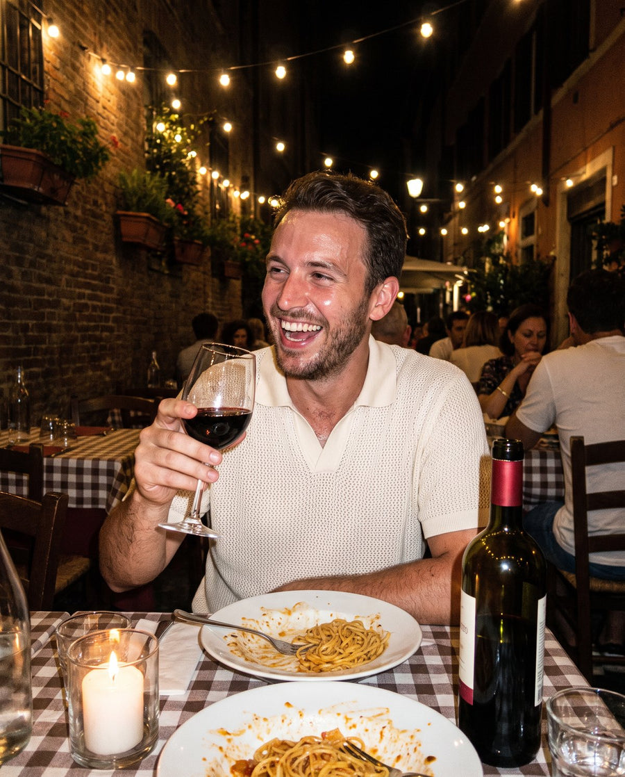 Man in a cream knit polo at dinner